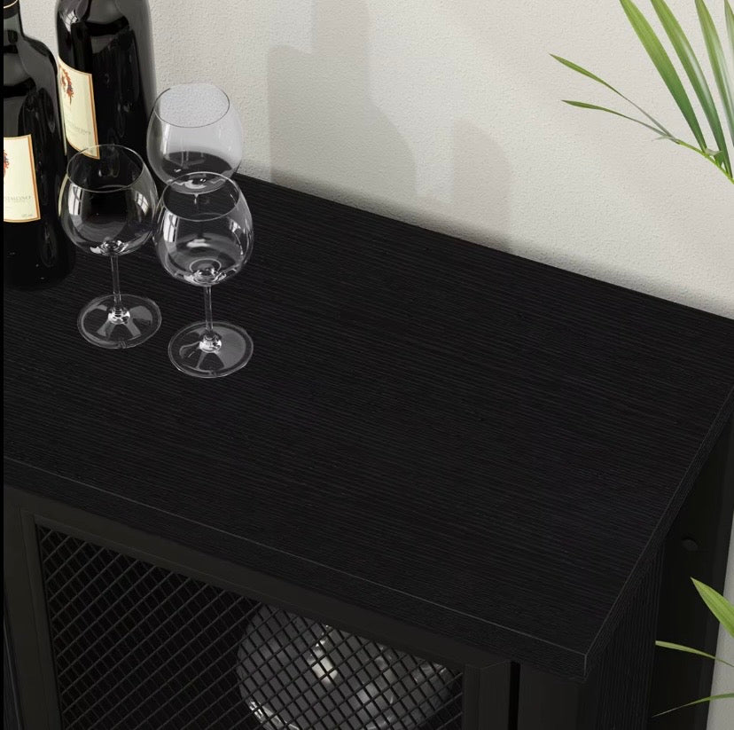 Black metal wine cabinet top with glassware and mesh door front panel